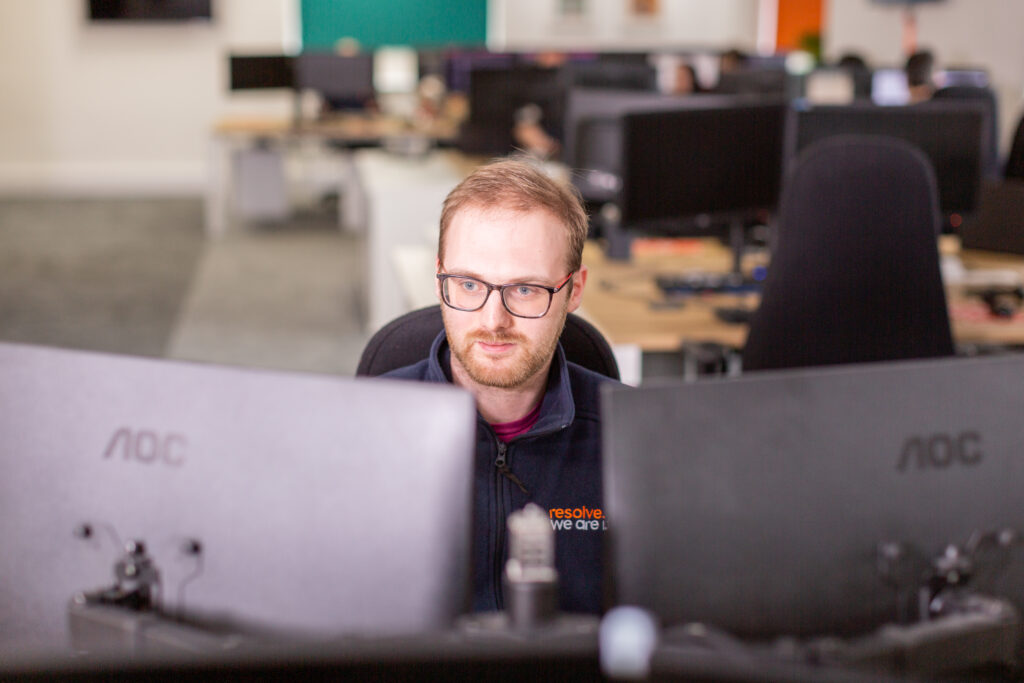 man looking at computers