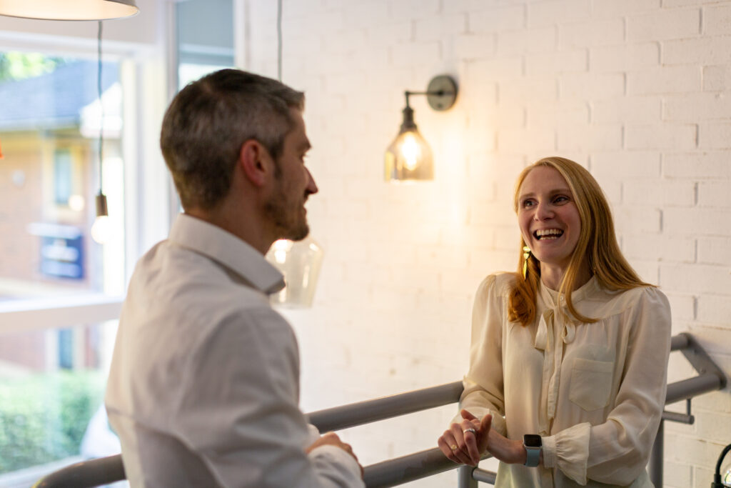 man and woman smiling and chatting together