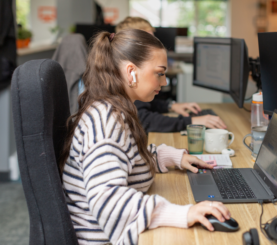 Female staff member sat at computer