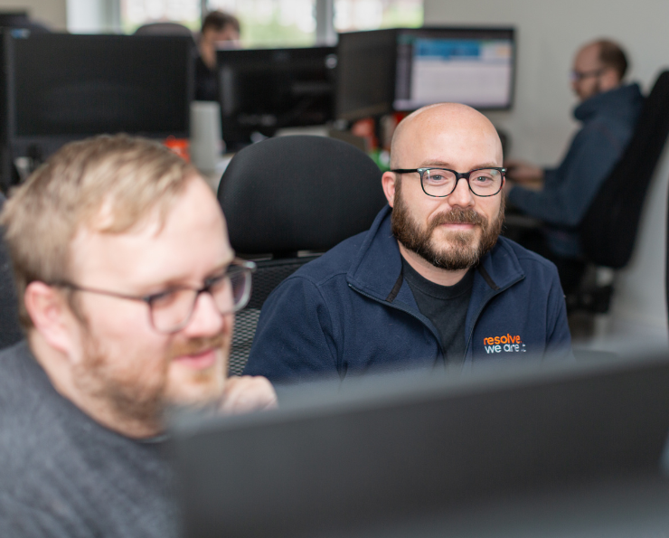 Photograph of two staff looking at a computer
