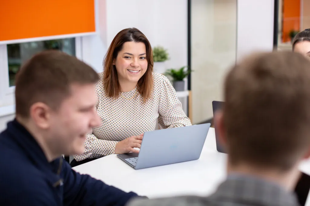 woman with laptop smiling