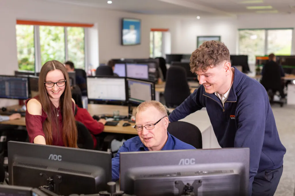 three people looking at computeer